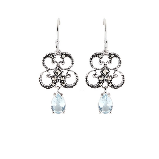 Pair of silver earrings with teardrop-shaped gemstones on a white background