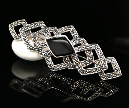 Art deco tesselated brooch with marcasite and onyx in sterling silver