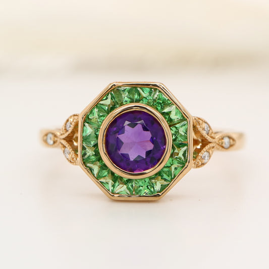 Target ring with channel set tsavorite garnet and amethyst with diamonds on the band in yellow gold