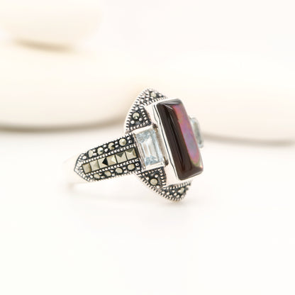 Silver lipped grey shell and pale blue topaz ring with marcasite and sterling silver