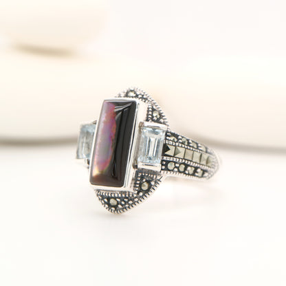 Silver lipped grey shell and pale blue topaz ring with marcasite and sterling silver