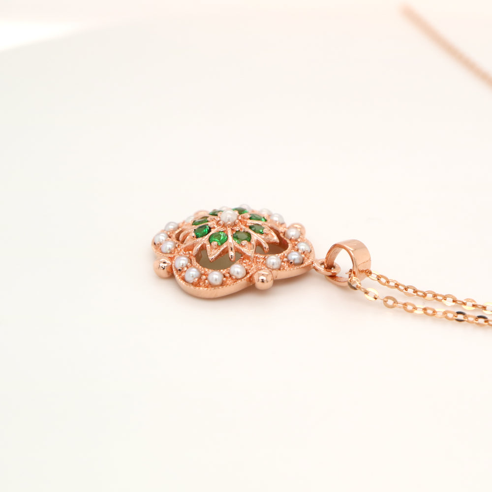 Pearl and tsavorite garnet pendant in 9k rose gold
