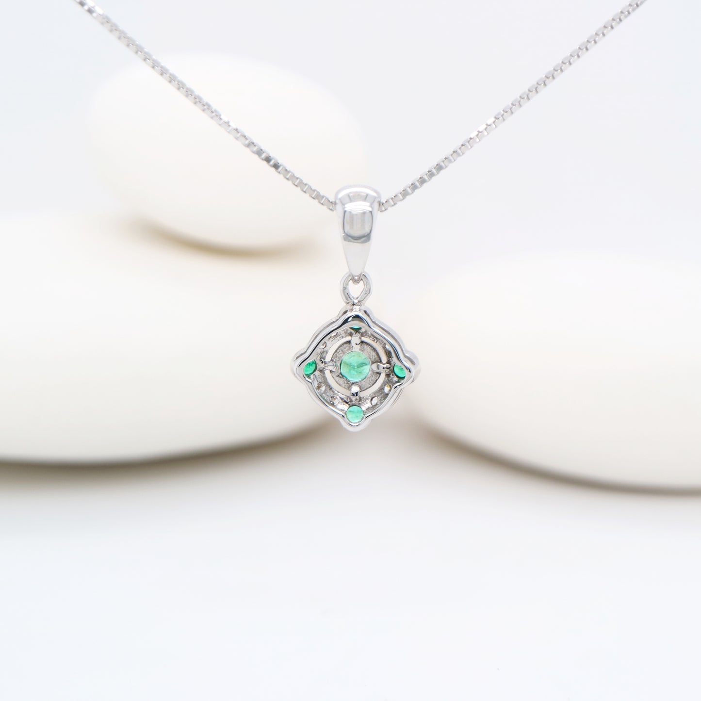 Emerald and diamond Circular pendant in 9k white gold