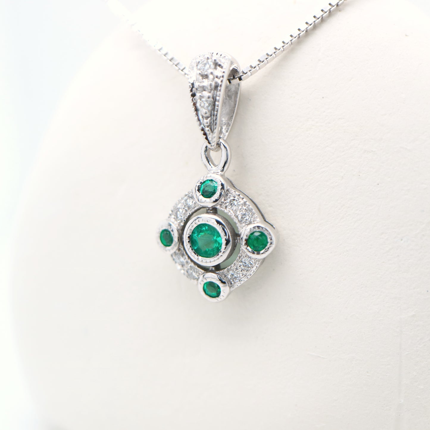 Emerald and diamond Circular pendant in 9k white gold