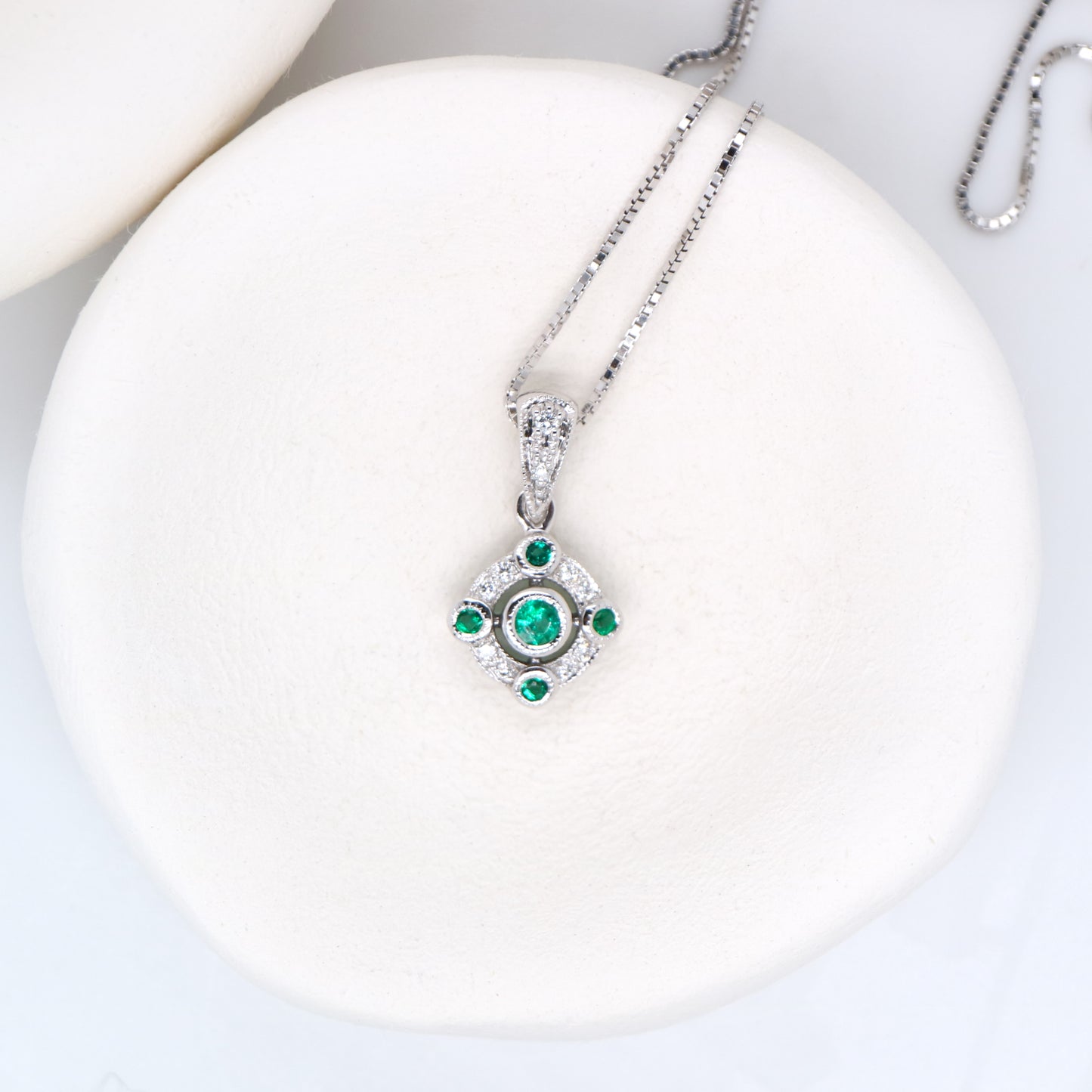 Emerald and diamond Circular pendant in 9k white gold
