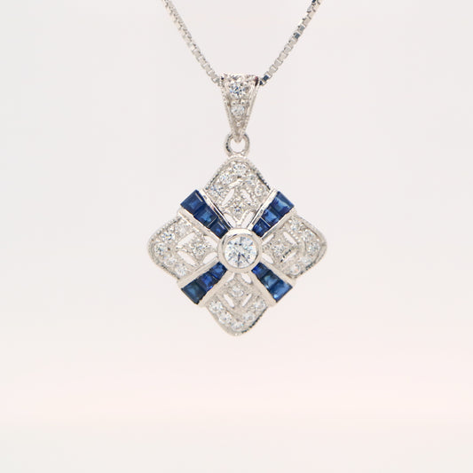 Art deco natural sapphire and diamond pendant in cross over design set in 9k white gold