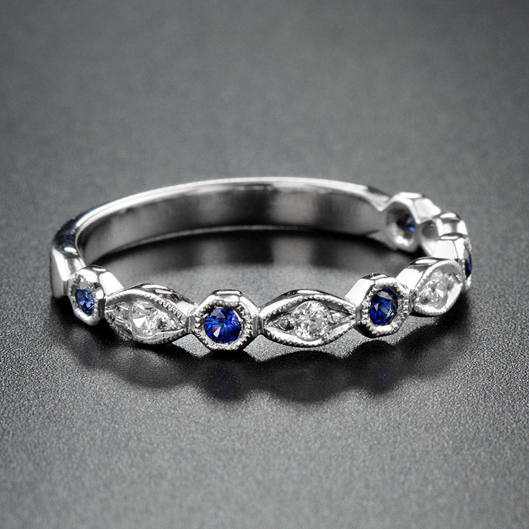 Silver ring with blue gemstones on a gray background