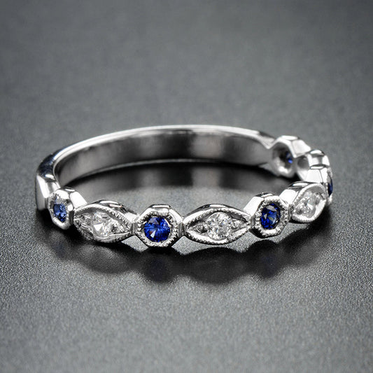 Silver ring with blue gemstones on a gray background