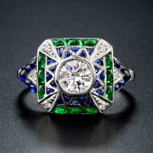 Cabochon set emerald sapphire diamond ring in white gold