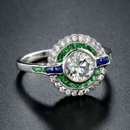 Moissanite and emerald target ring with sapphire accents in white gold