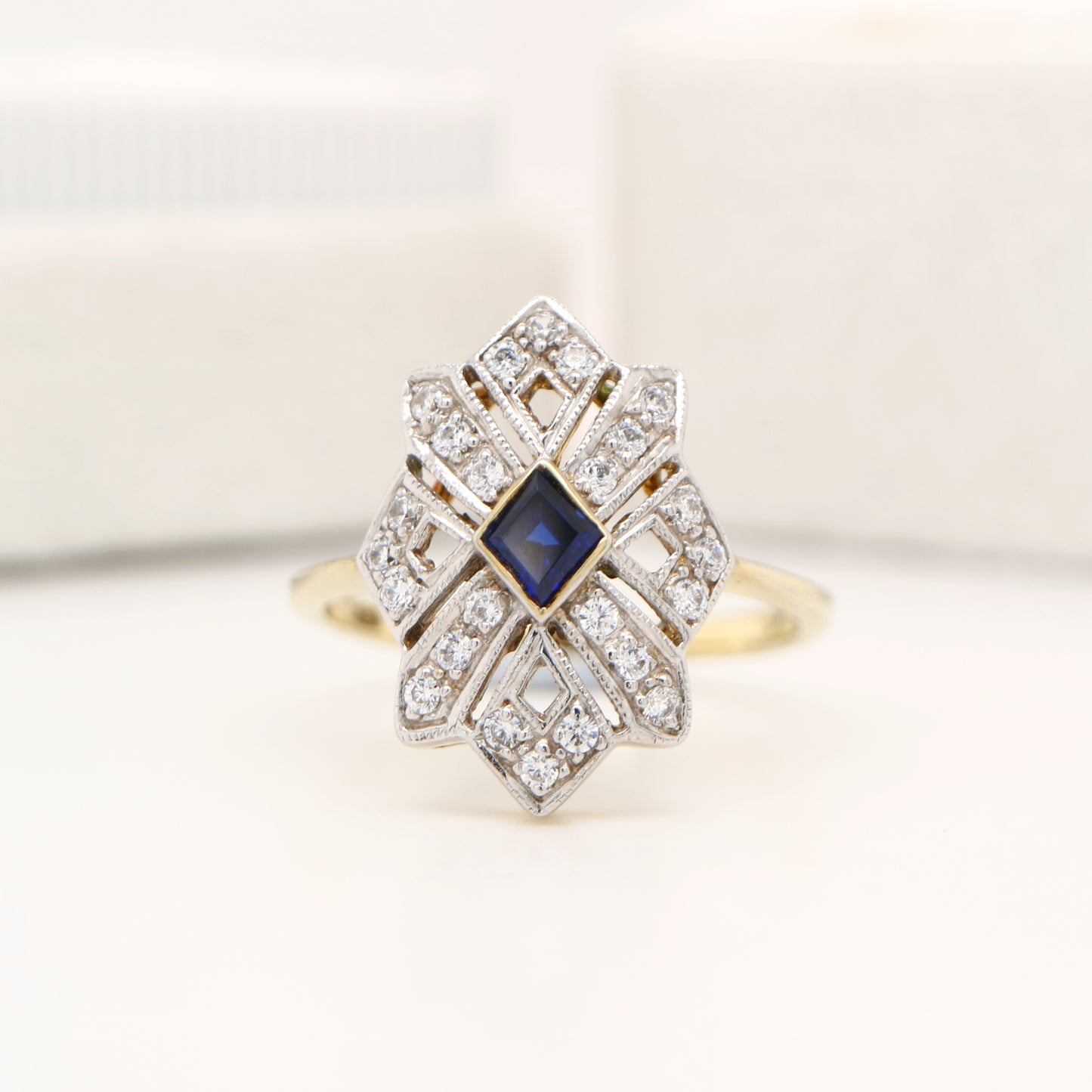 Starburst shield ring with natural sapphire and diamond in twin gold
