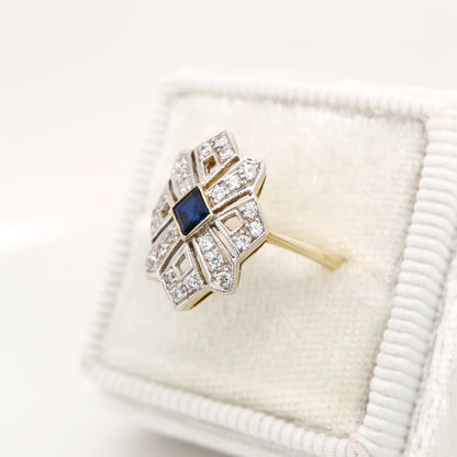 Starburst shield ring with natural sapphire and diamond in twin gold