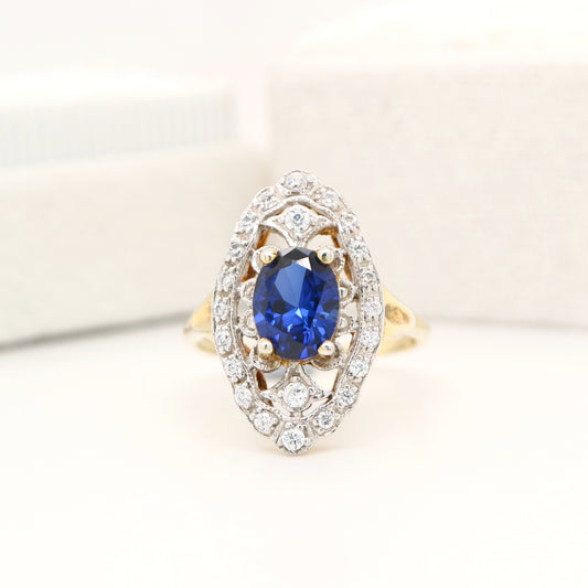 Blue sapphire and diamond cocktail shield ring in twin gold
