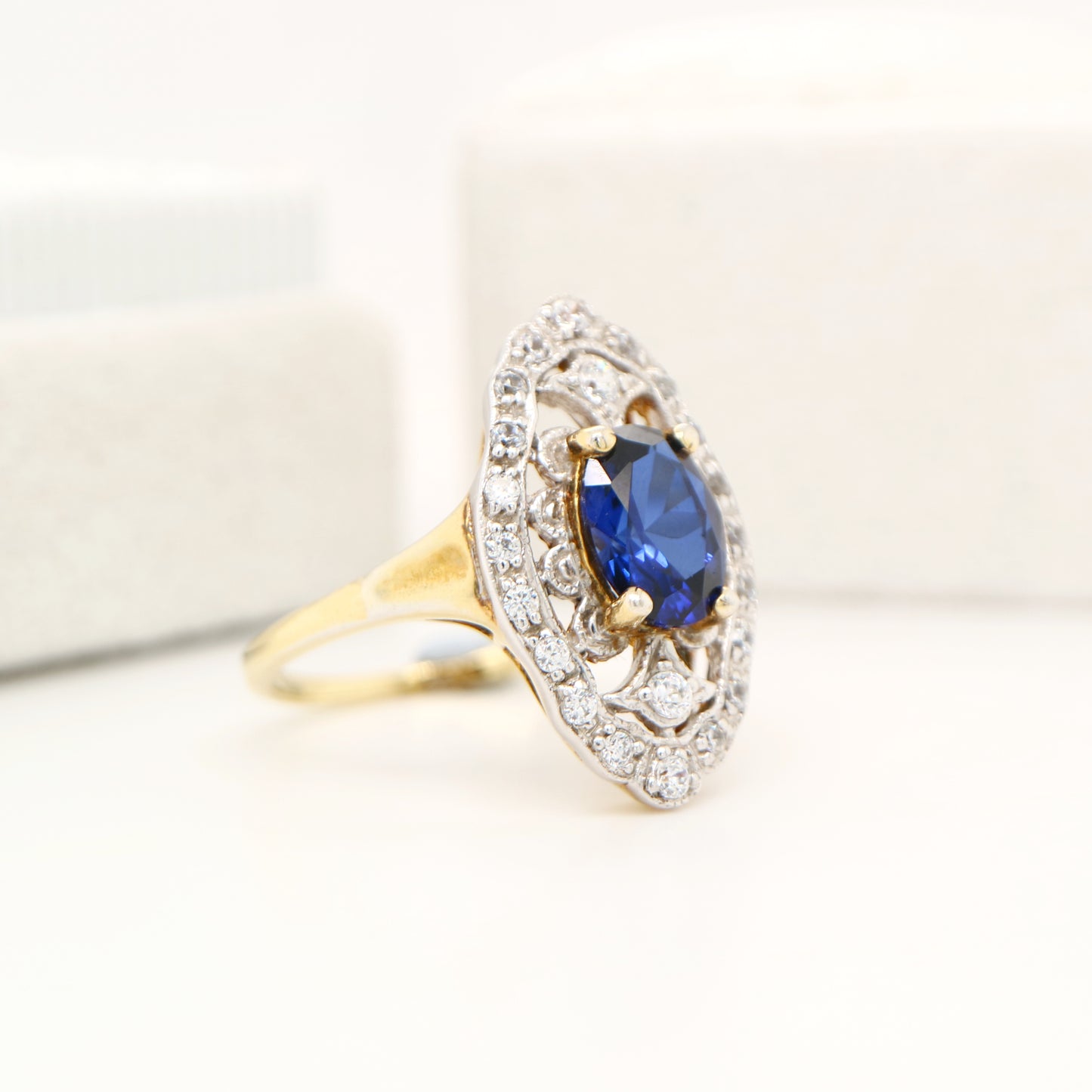 Blue sapphire and diamond cocktail shield ring in twin gold