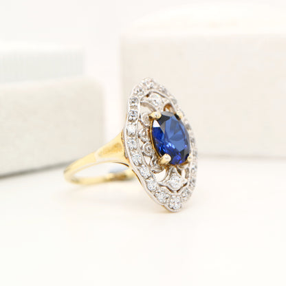 Blue sapphire and diamond cocktail shield ring in twin gold