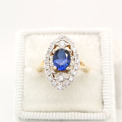 Blue sapphire and diamond cocktail shield ring in twin gold