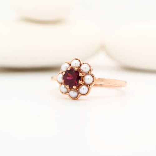 Garnet with pearl halo ring in 9k rose gold