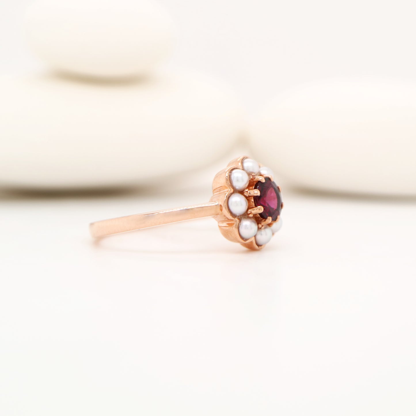 Garnet with pearl halo ring in 9k rose gold