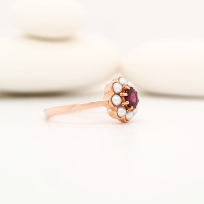 Garnet with pearl halo ring in 9k rose gold