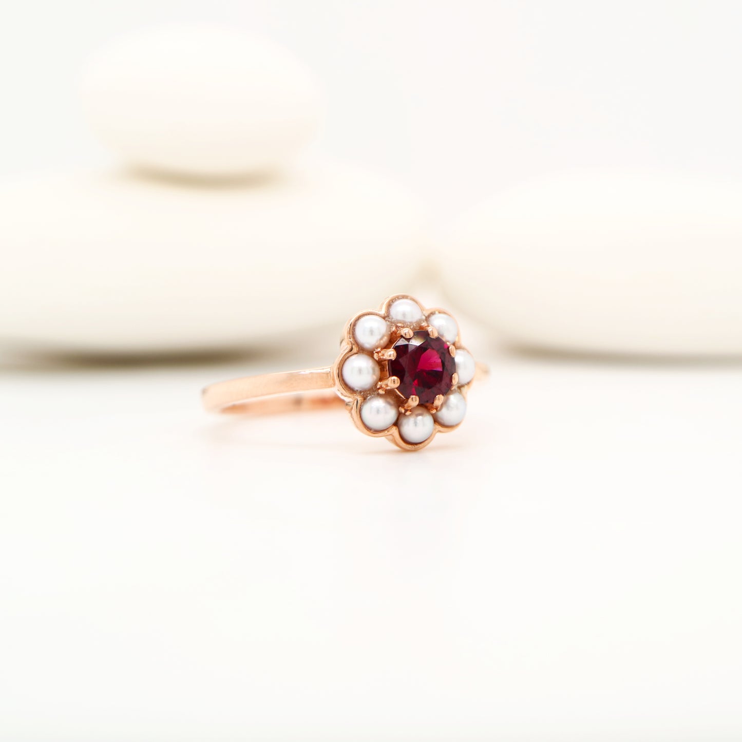 Garnet with pearl halo ring in 9k rose gold