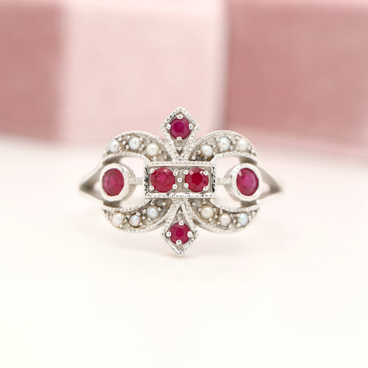 White gold fleur-de-lis ring with ruby and seed pearl