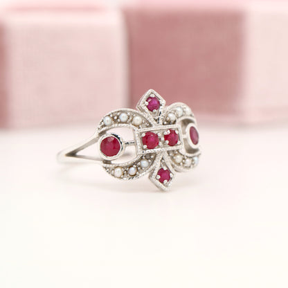 White gold fleur-de-lis ring with ruby and seed pearl