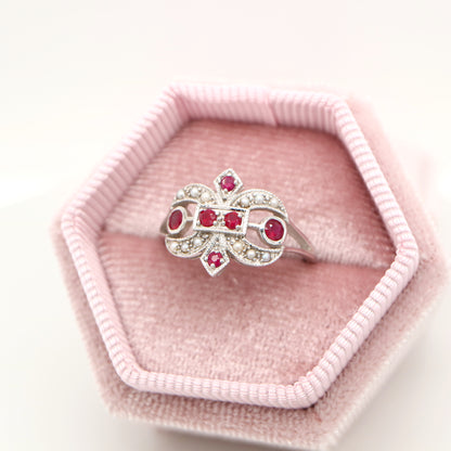 White gold fleur-de-lis ring with ruby and seed pearl