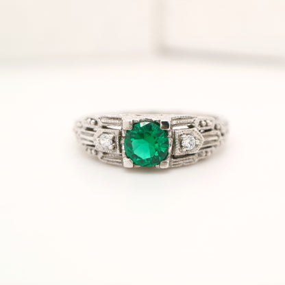 Art deco white gold ring with center emerald and shoulder diamond