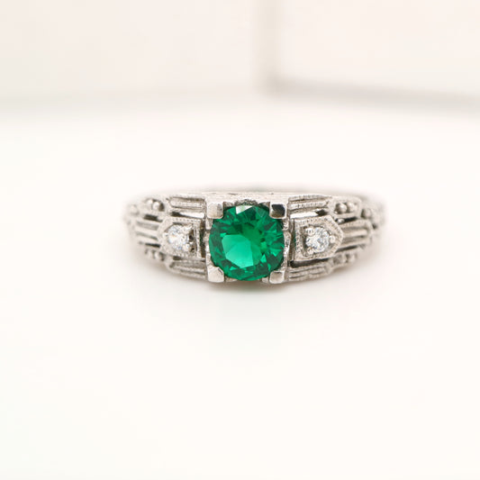 Art deco white gold ring with center emerald and shoulder diamond