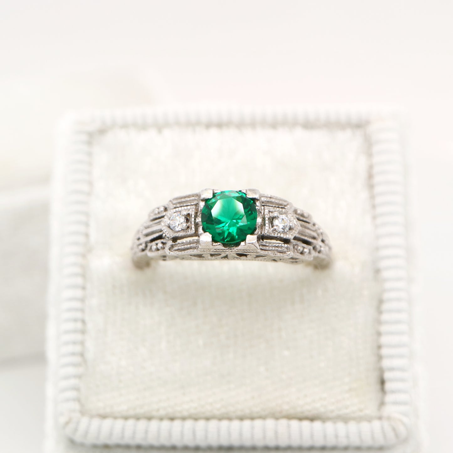 Art deco white gold ring with center emerald and shoulder diamond