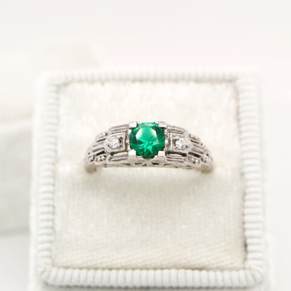Art deco white gold ring with center emerald and shoulder diamond