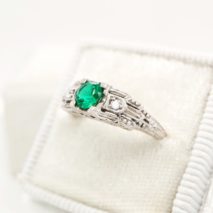 Art deco white gold ring with center emerald and shoulder diamond