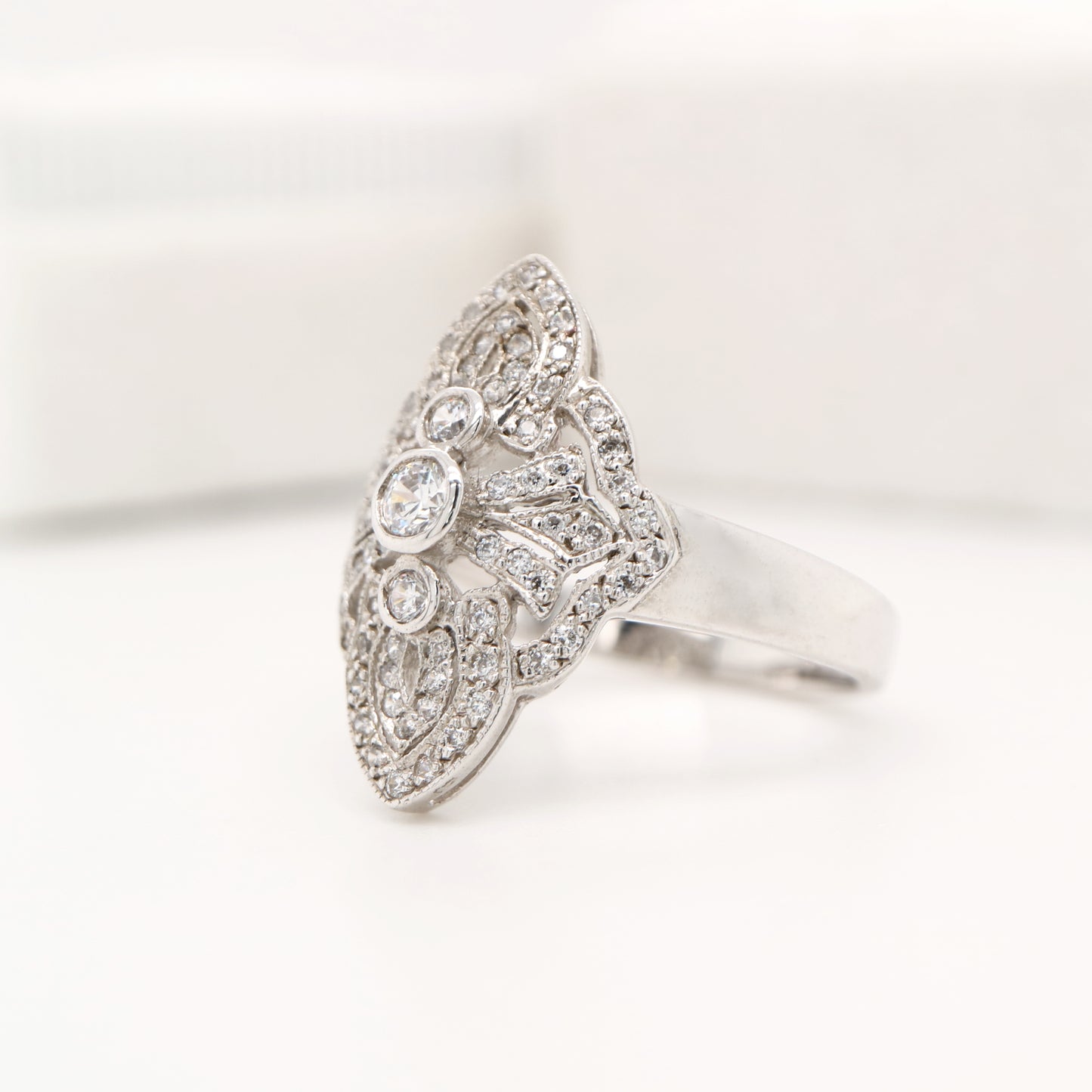 Vintage filigree shield ring in white gold with natural diamonds