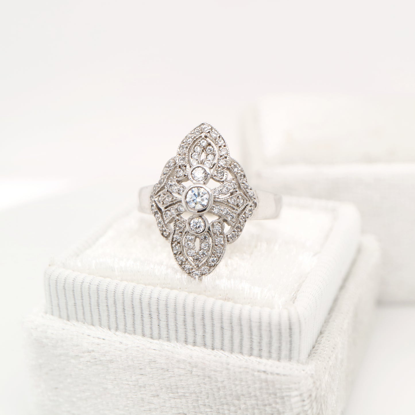 Vintage filigree shield ring in white gold with natural diamonds