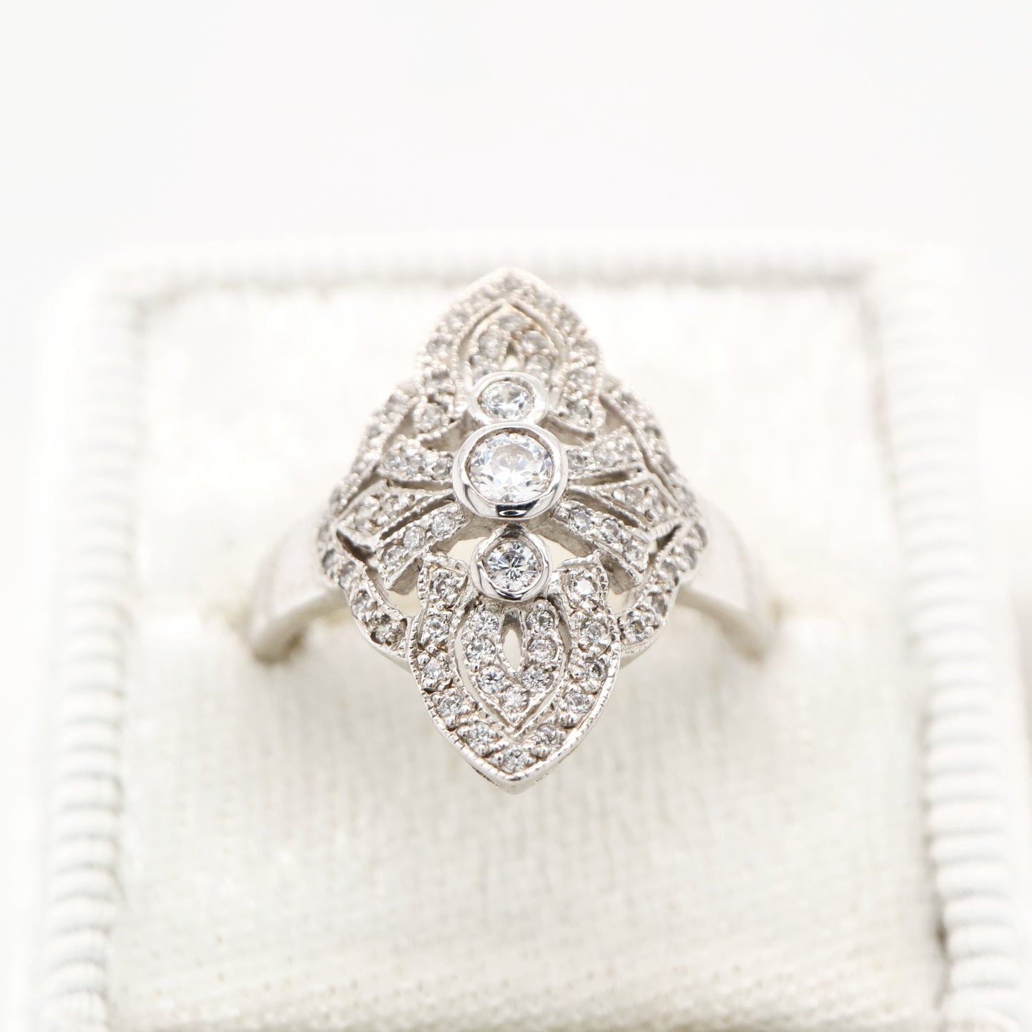 Vintage filigree shield ring in white gold with natural diamonds