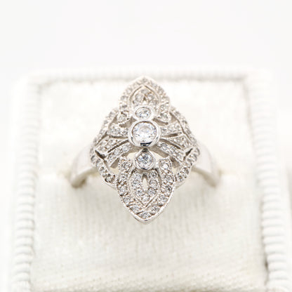 Vintage filigree shield ring in white gold with natural diamonds