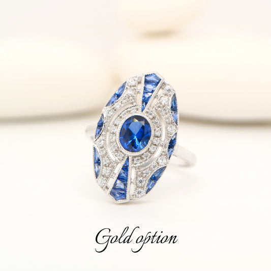 9k white gold shield ring with sapphire and diamond