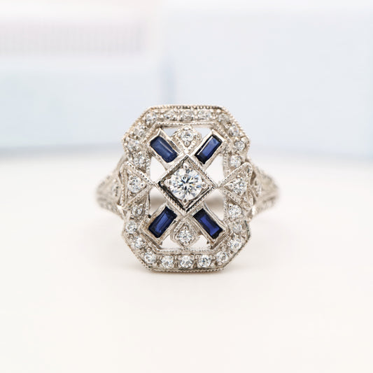 Diamond shield ring with sapphire accents in white gold