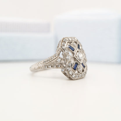 Diamond shield ring with sapphire accents in white gold
