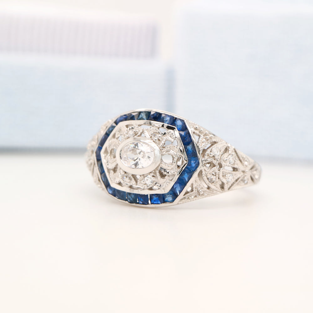 Art deco white gold ring with diamond and sapphire halo