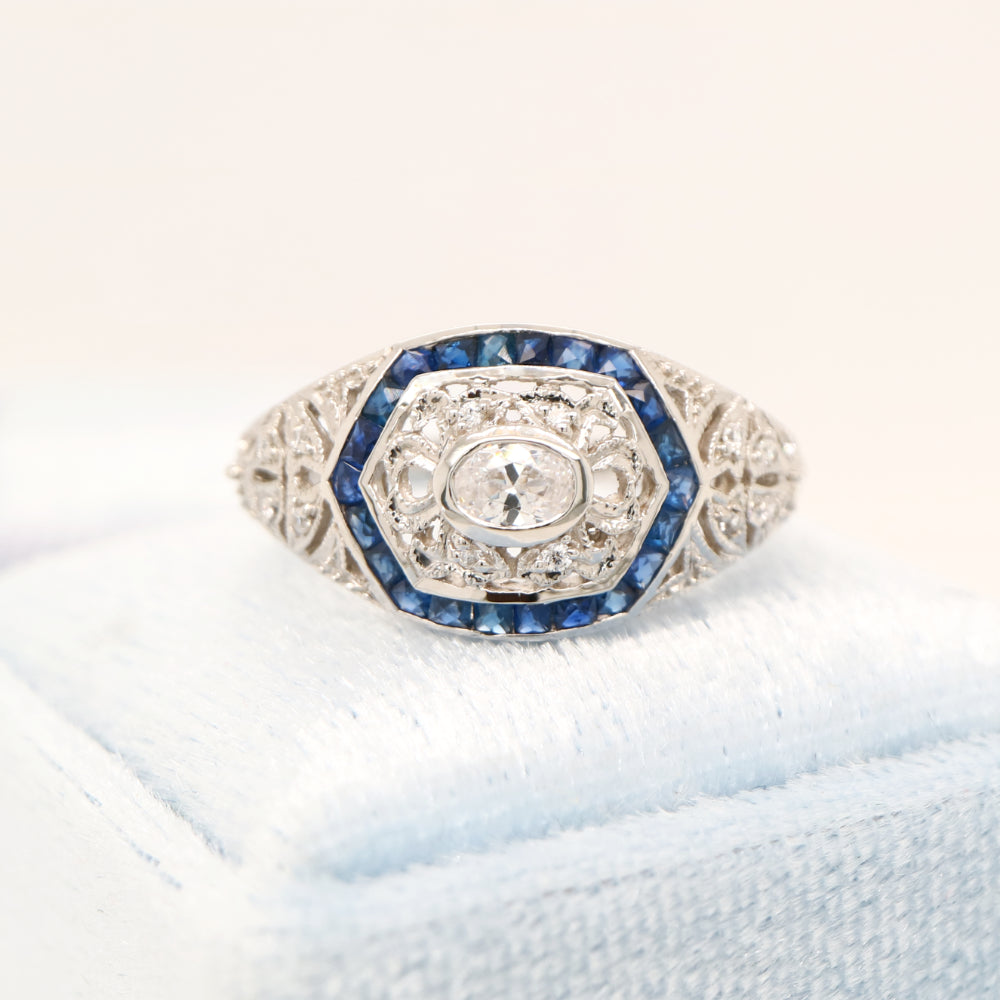 Art deco white gold ring with diamond and sapphire halo