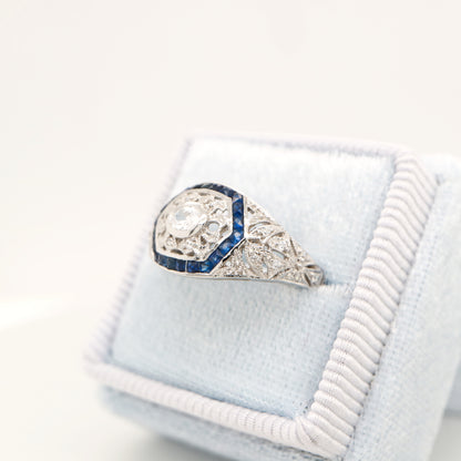 Art deco white gold ring with diamond and sapphire halo