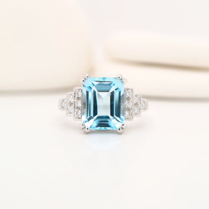 Blue topaz solitaire with diamonds in white gold