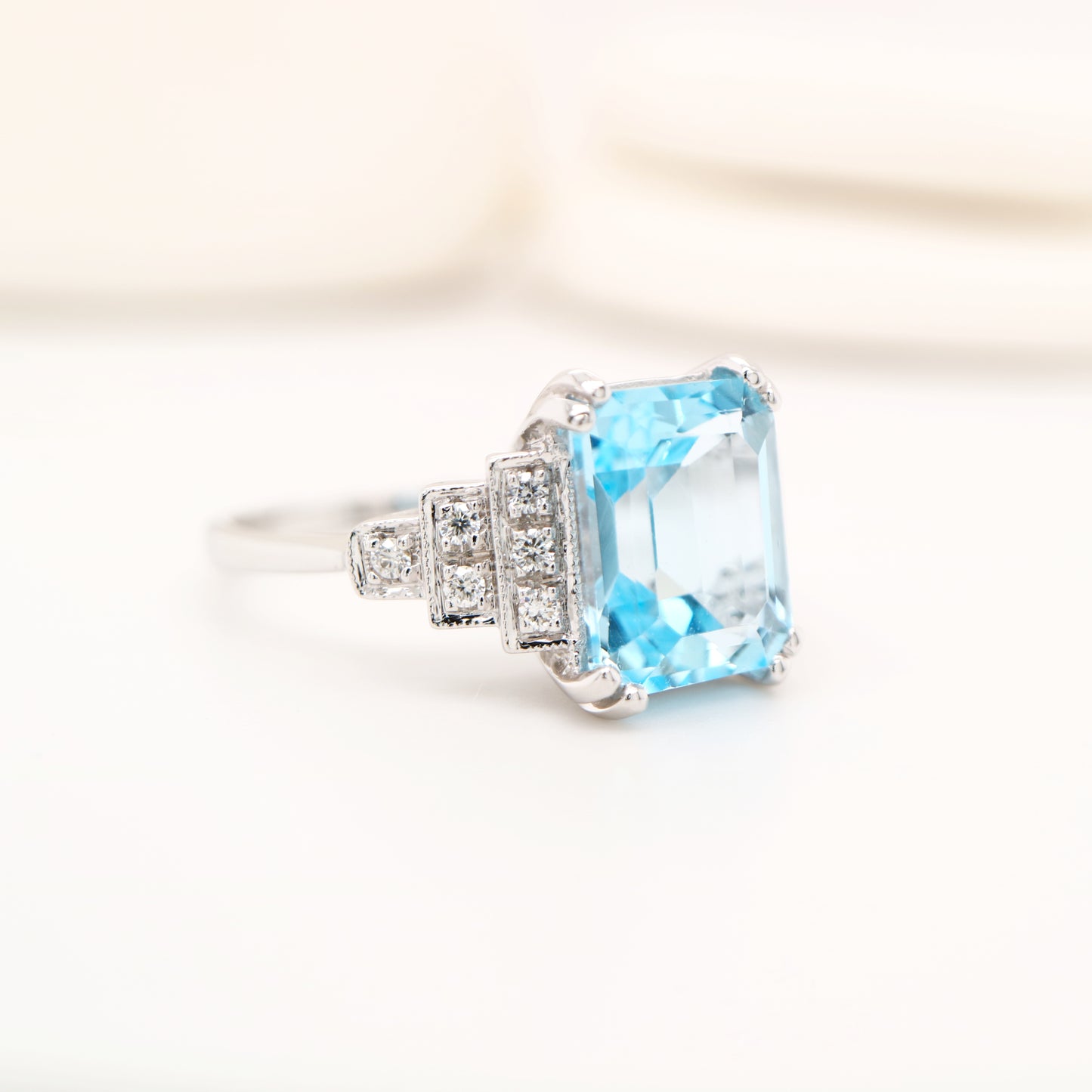 Blue topaz solitaire with diamonds in white gold