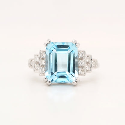 Blue topaz solitaire with diamonds in white gold