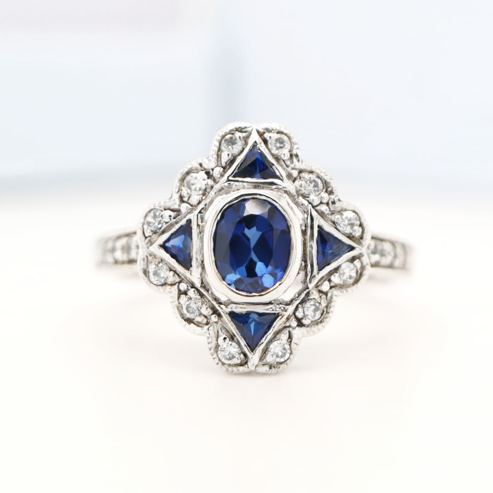 Art deco sapphire starburst white gold ring with diamond halo