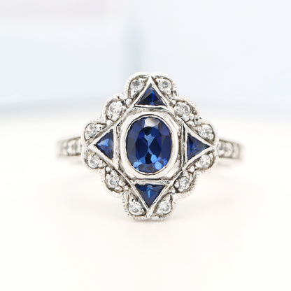 Art deco sapphire starburst white gold ring with diamond halo