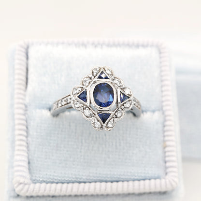 Art deco sapphire starburst white gold ring with diamond halo