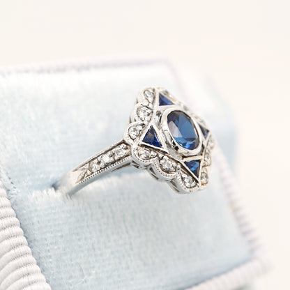 Art deco sapphire starburst white gold ring with diamond halo
