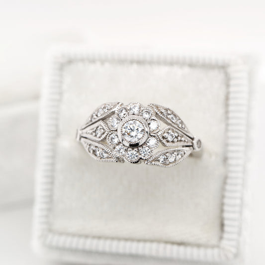 Flower and petal ring with diamonds in white gold